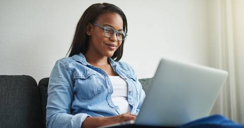 Woman with laptop on couch
