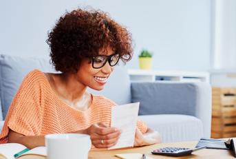 african american woman calculating home finances