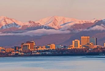 sun setting over anchorage skyline