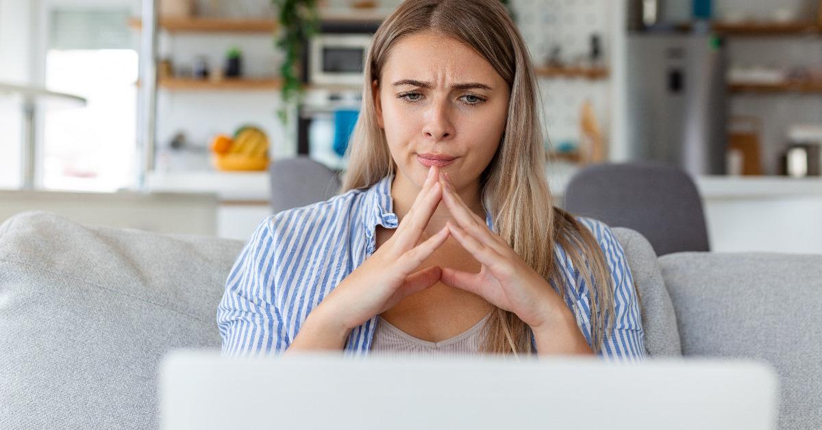 annoyed woman using laptop for work