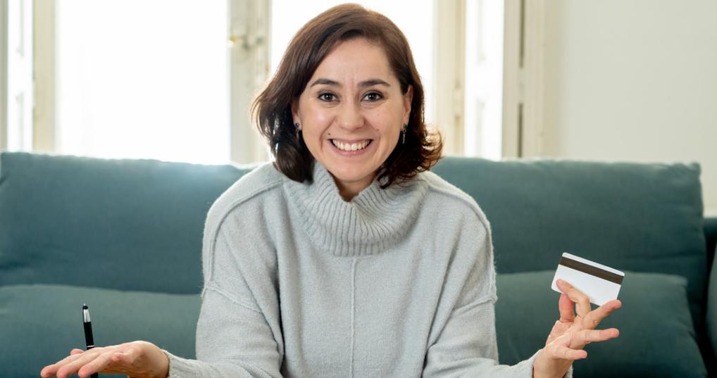 Smiling woman holding credit card