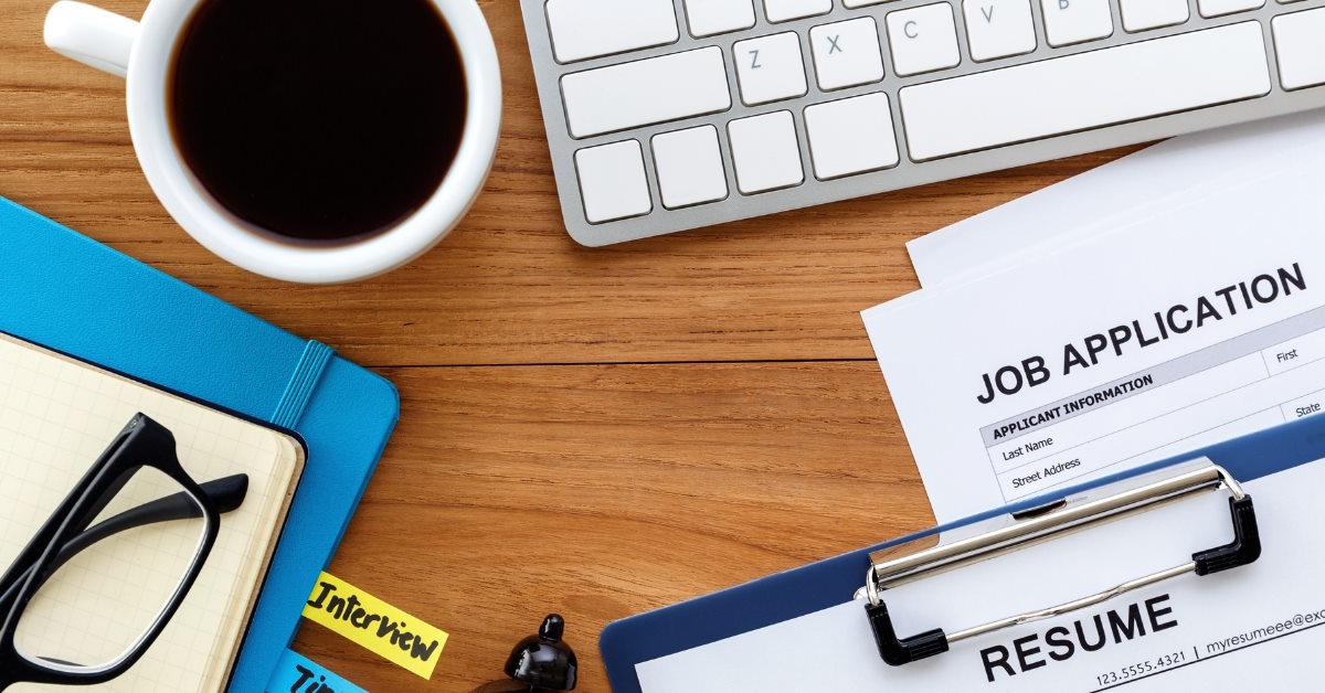 desk witth job applications and resume