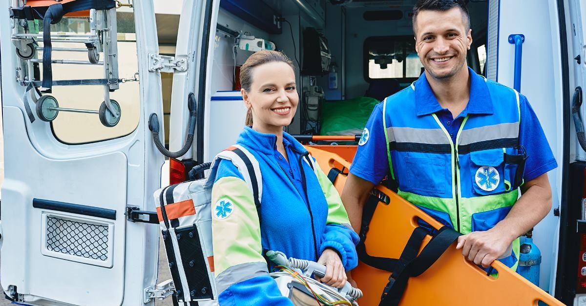 emergency medical technicians standing at the back of ambulance