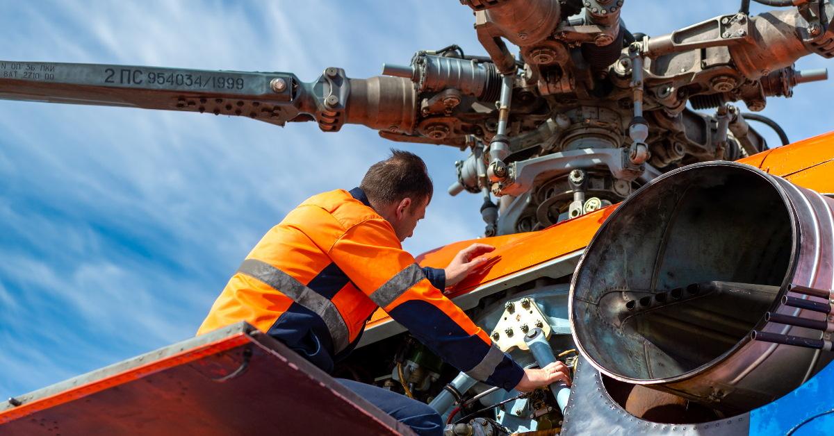 engineer inspecting helicopter