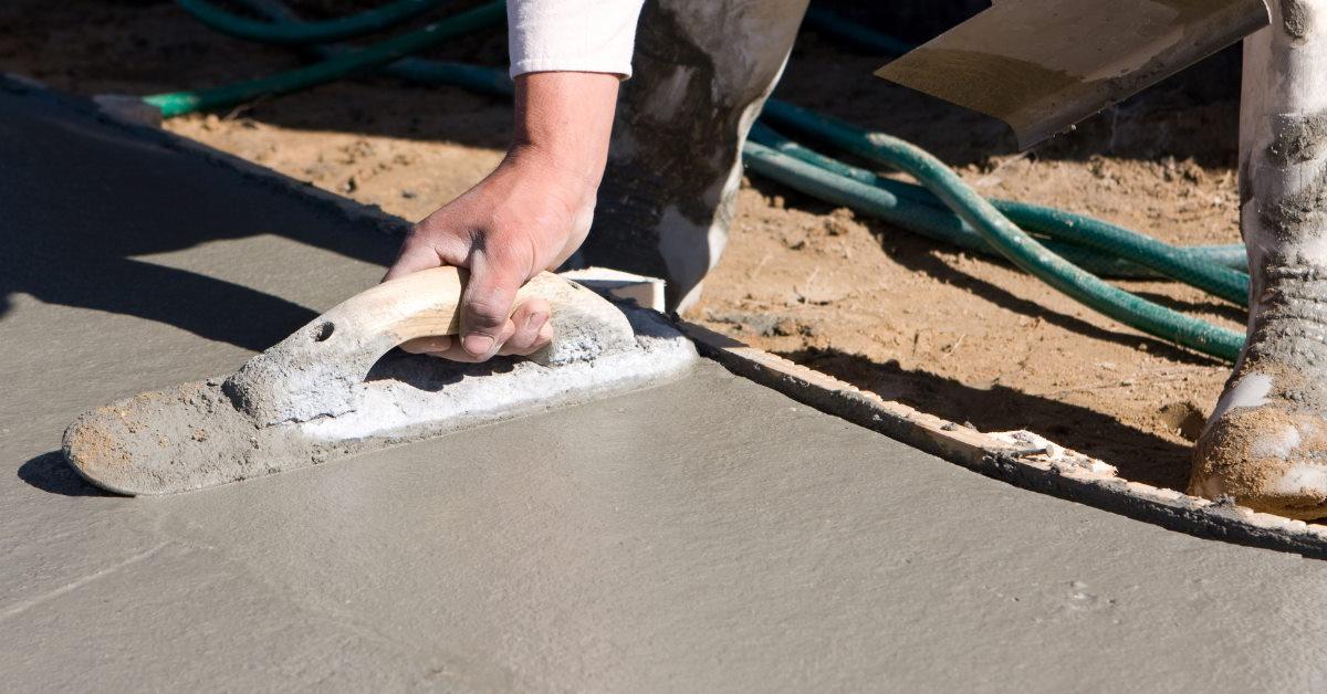 man finishing concrete sidewalk