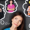 female student standing in front of black background think about available career options
