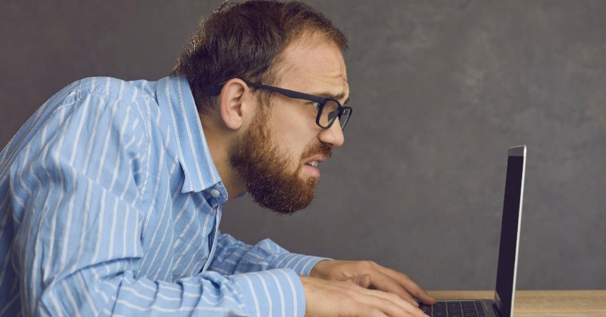frustrated buisnessman typing on laptop keyboard