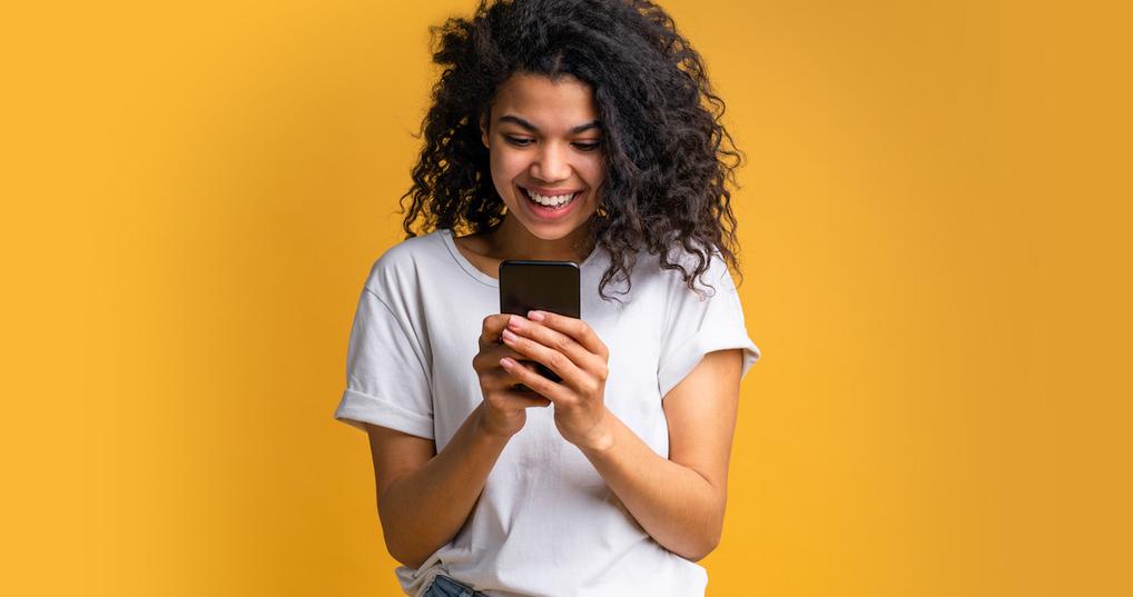 Happy woman holding smartphone