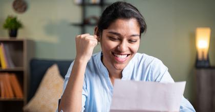 Happy woman reading letter