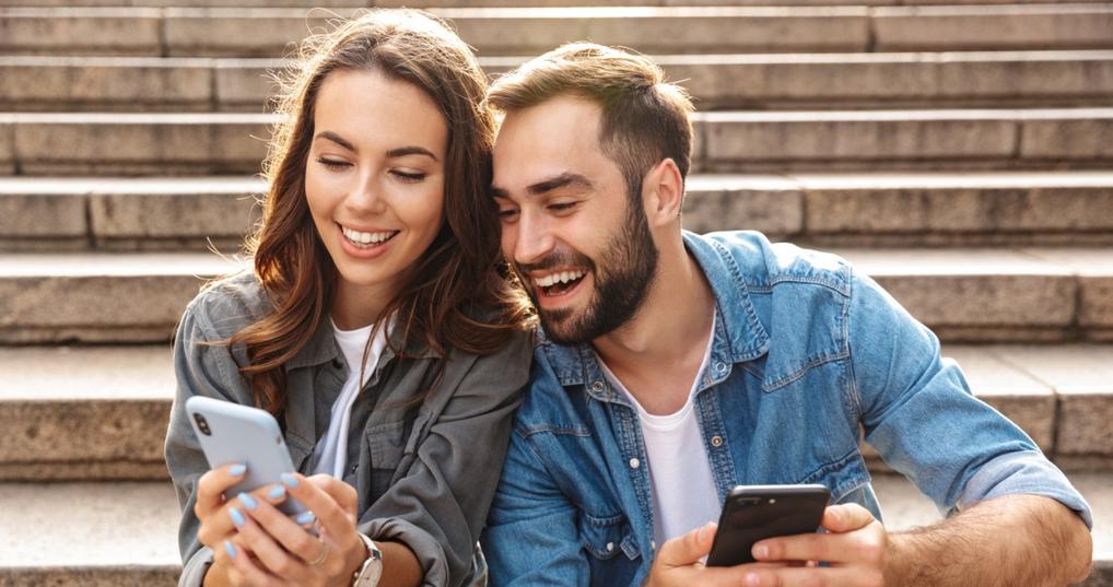 Smiling couple looking at smartphone