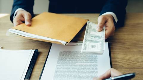 Man signing paperwork for a personal loan