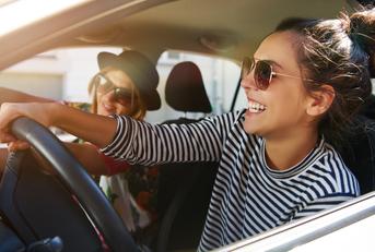 Laughing girls driving car