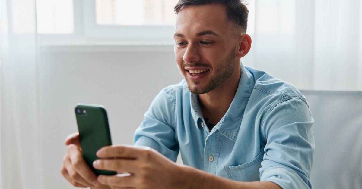 male influencer using smartphone at home