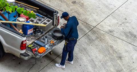 An adult man offering home services with a pickup truck