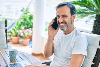 middle age man with beard smiling happy at the terrace 