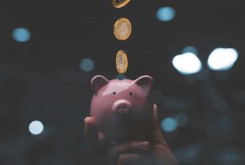 Money going into a piggy bank