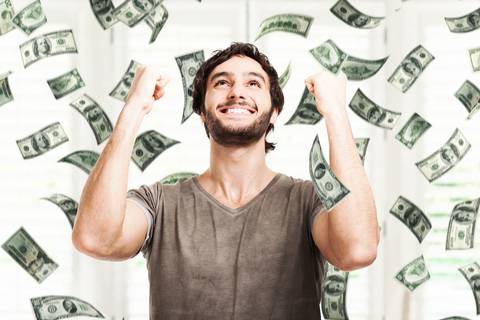 Money raining on man