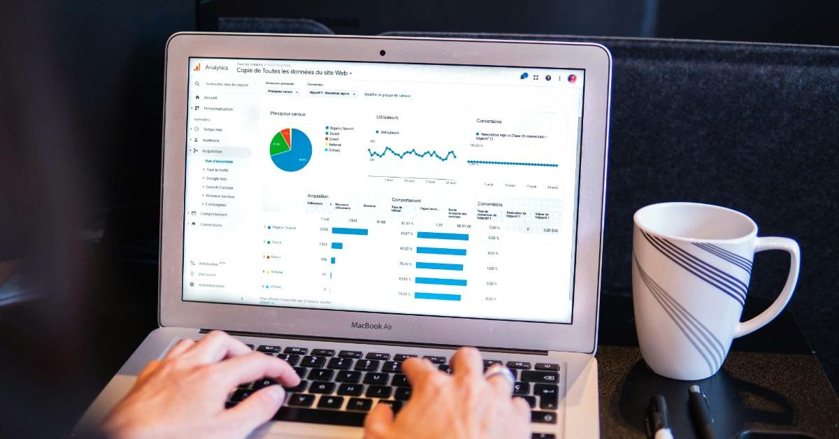person using macbook pro on table