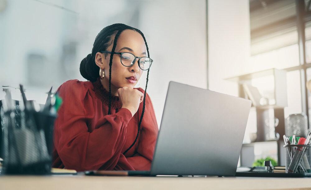 Thinking woman on computer