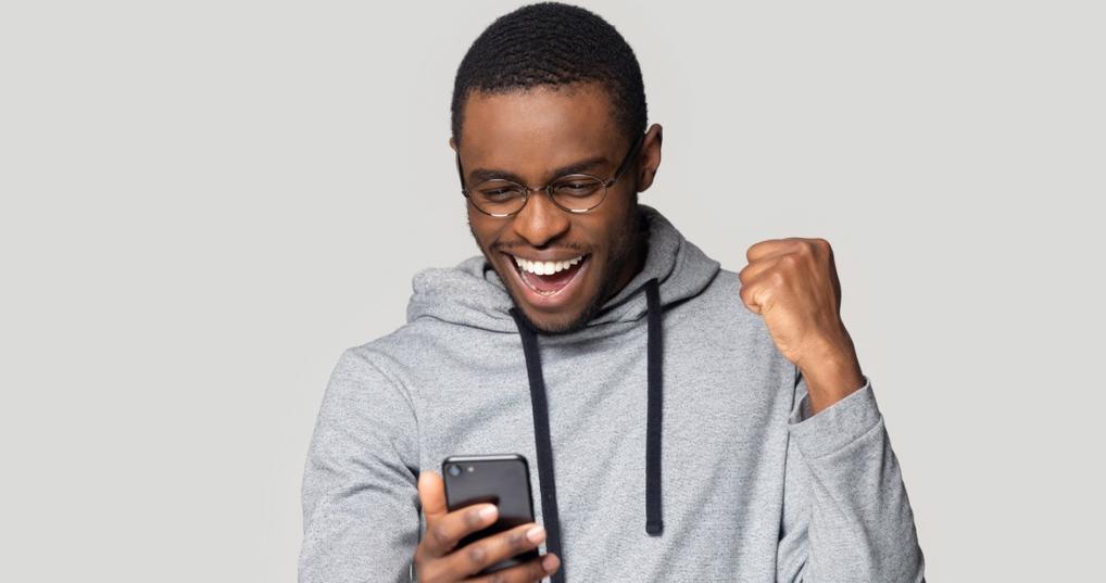 Smiling man looking at smartphone