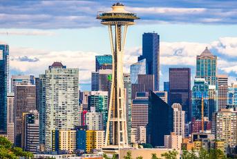 green trees in front of skyscrapers of seattle washington during day time with clear sky