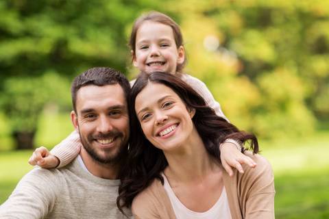 Smiling family outside