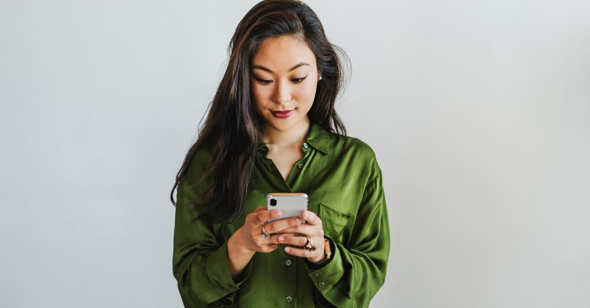 Smiling woman looking at phone