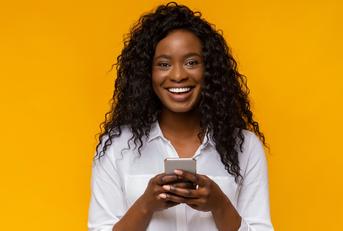 Smiling woman using phone