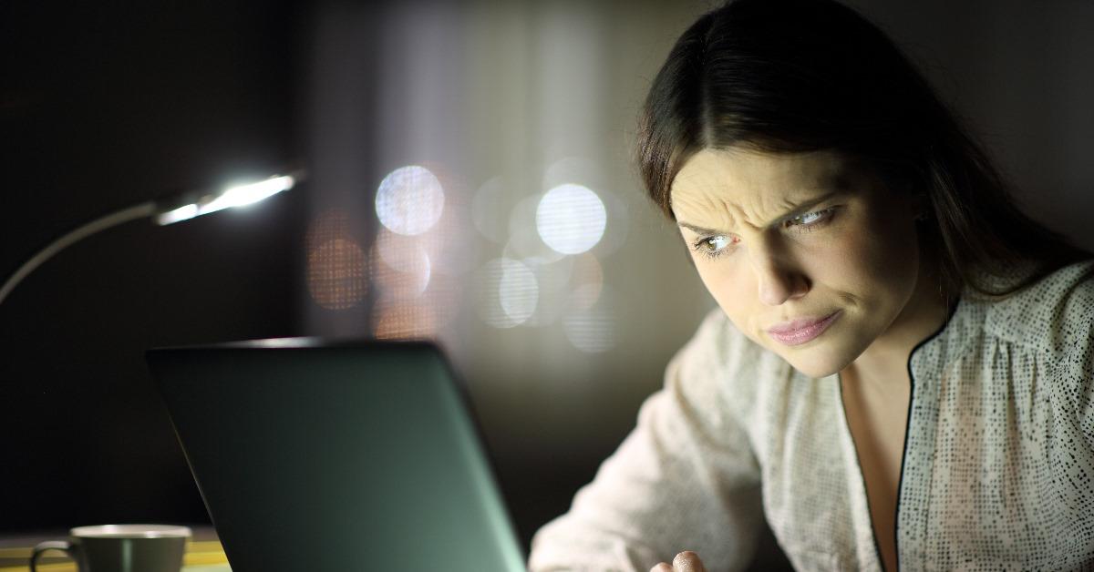suspicious woman using laptop late at night