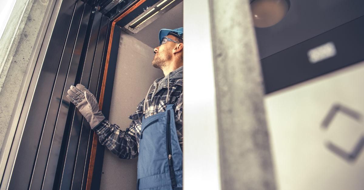 technician fixing building elevator
