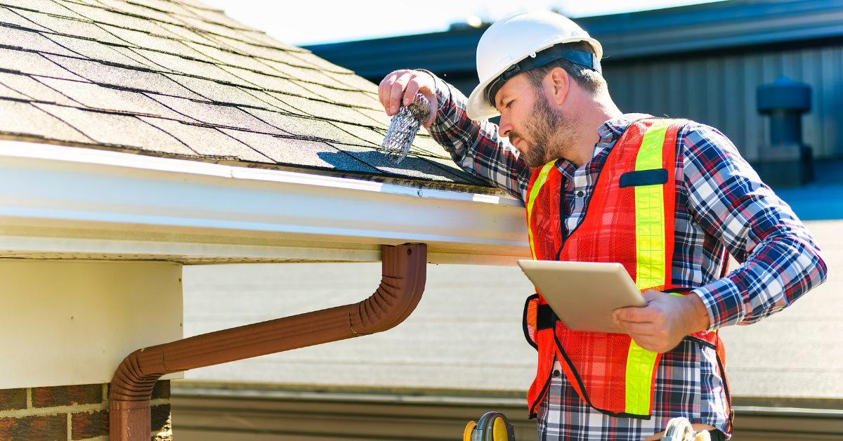 male tehnician inspecting roof top leakage