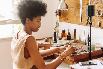 woman making handmade jewelry