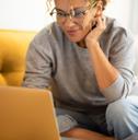 A woman using her laptop to complete surveys