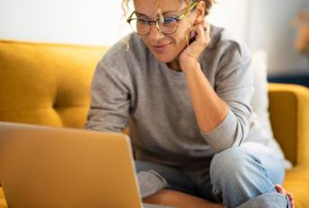 A woman using her laptop to complete surveys