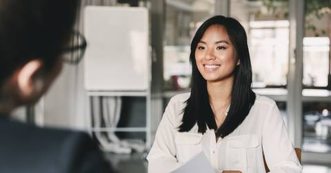 woman smiling and holding resume