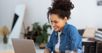 Woman using a computer and smiling