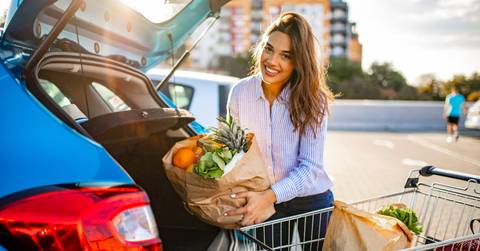  woman walking to the car after shopping at the supermarket