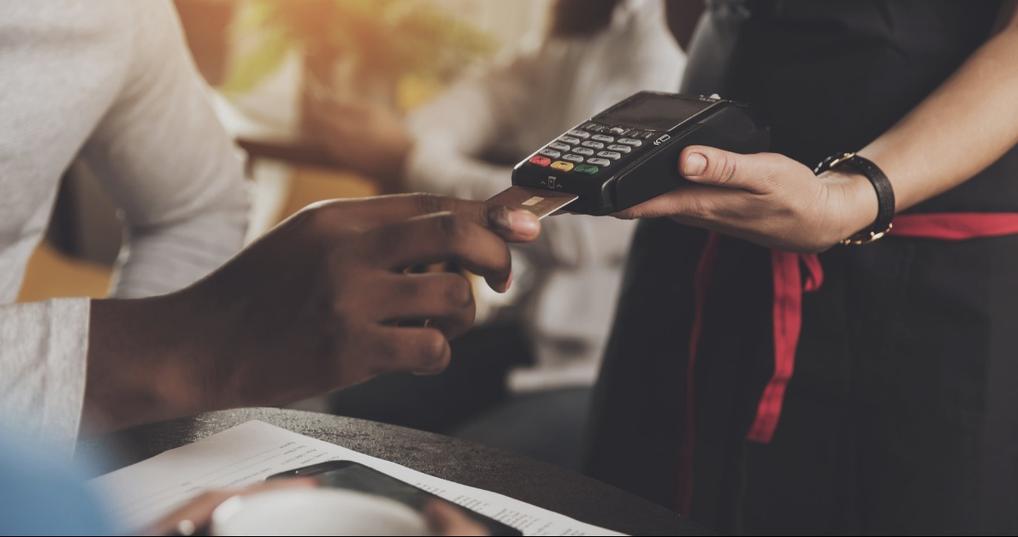 Man at a restaurant paying with a secured credit card