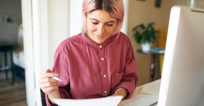 Young woman looking at a bill