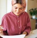 Young woman looking at a bill