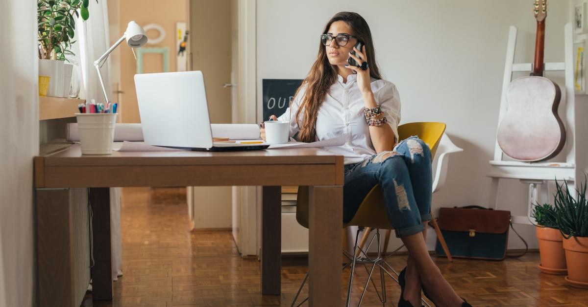 young woman working on a computer in her home office