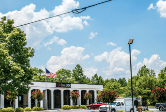 The Bank of the Ozarks with an American Flag and blue sky.