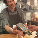 A customer inserts their credit card into a credit card reader.