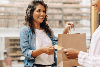 Happy woman shops with credit card