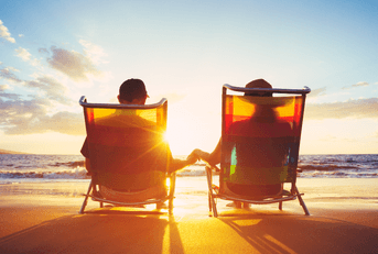 Retired couple sitting on the beach