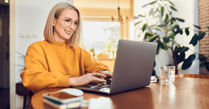 A woman uses her laptop at home.