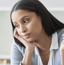 Woman holding a credit card looking stressed